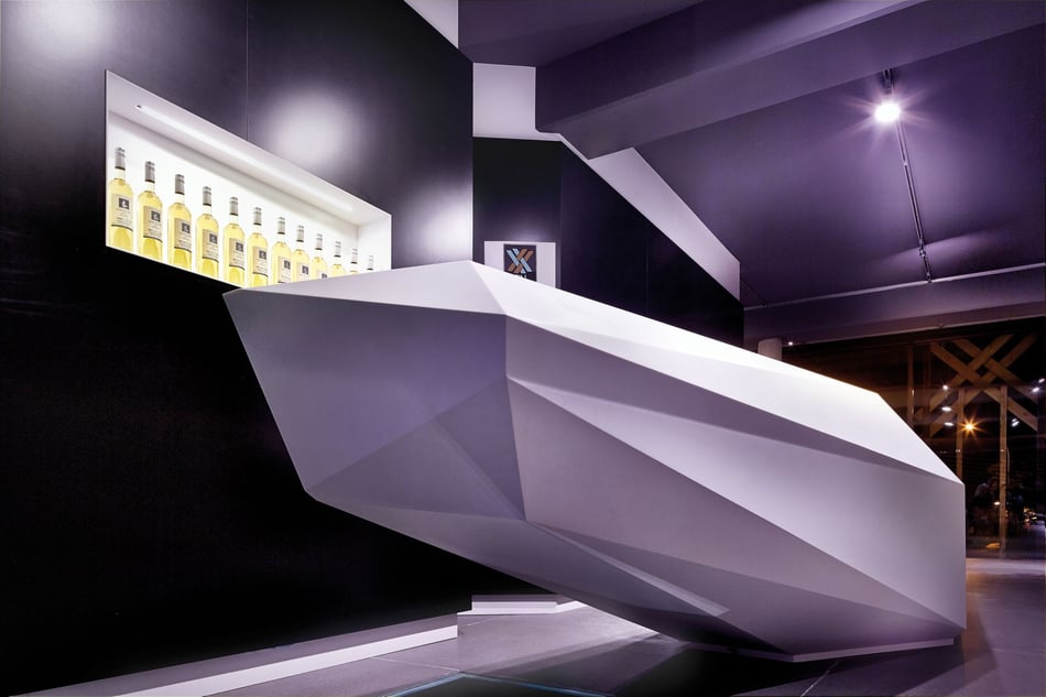 Polygonale-Theke-aus-weissem-Mineralwerkstoff-im-Weinkorb-im-Remstal-mit-moderner-Beleuchtung