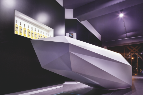 Detailaufnahme der kubistischen Corian-Theke in der Vinothek Weinkorb mit präziser Dreieckstopographie